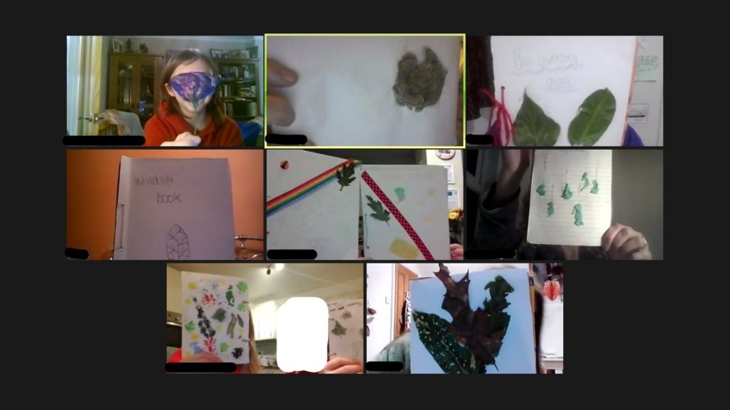 A screenshot of children holding up their artwork