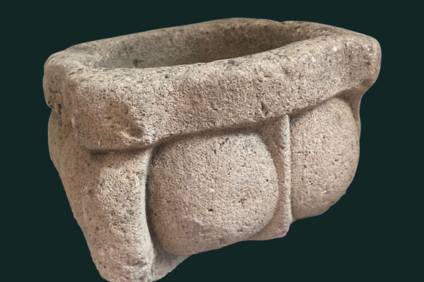 A hollow stone cuboid-shaped object, a