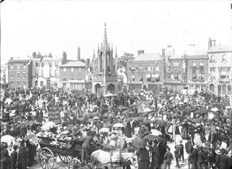 Black and white photograph of a crowd of people in Devizes Market Place