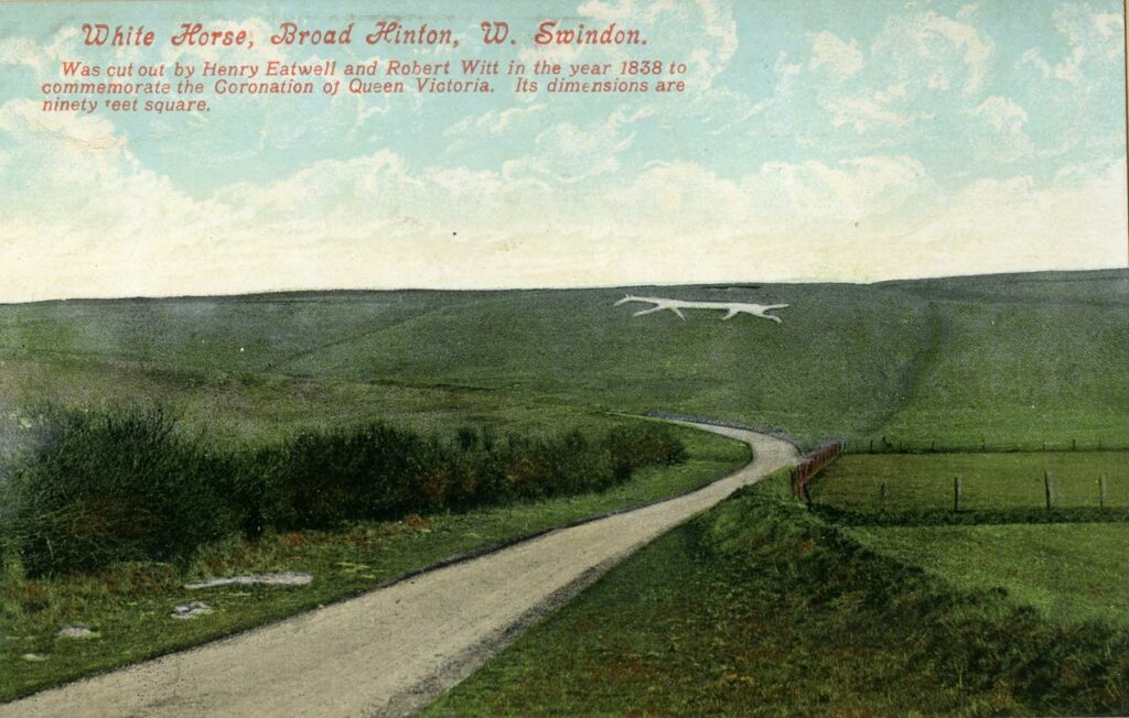 Coloured postcard of a hill with a chalk white horse